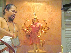 hindu swami at altar in queens